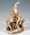 Rare, excellent porcelain group of the 19th century: youthful bacchus with nymph and putti grouped around a large wine...