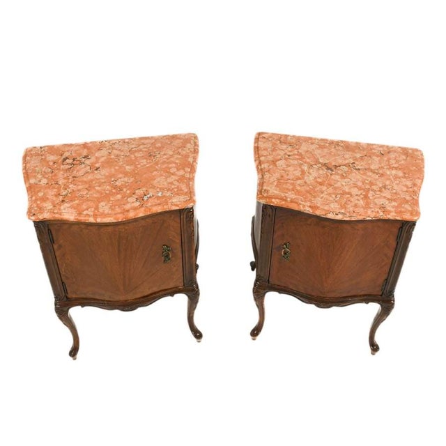 This antique pair of French walnut nightstands reflects refined craftsmanship and classic materials characteristic of...