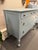This is a vintage mahogany chest painted blue. The legs are on castors. The drawers have a carved detail. The paint is...