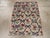 This mid-20th century Turkish Anatolian rug, measuring 2' 10" x 3' 10", presents a charming floral lattice design infused...