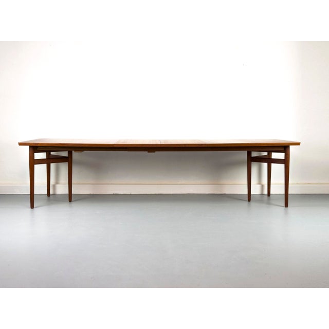 An impressive and rare teak dining table (model 201) by Arne Vodder for Sibast. The table captivates with its elegant,...