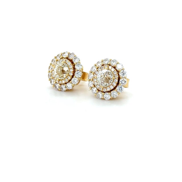 Diamond Cut: Crown of Light Carat weight: 1.29 carats (2) Setting: Prong Halo Round Brilliant Cut Diamonds: 0.20 carat...