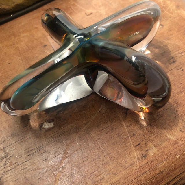 Art glass paper weight in a modern style star shaped pattern Clear with muted multi colors through out heavy weight