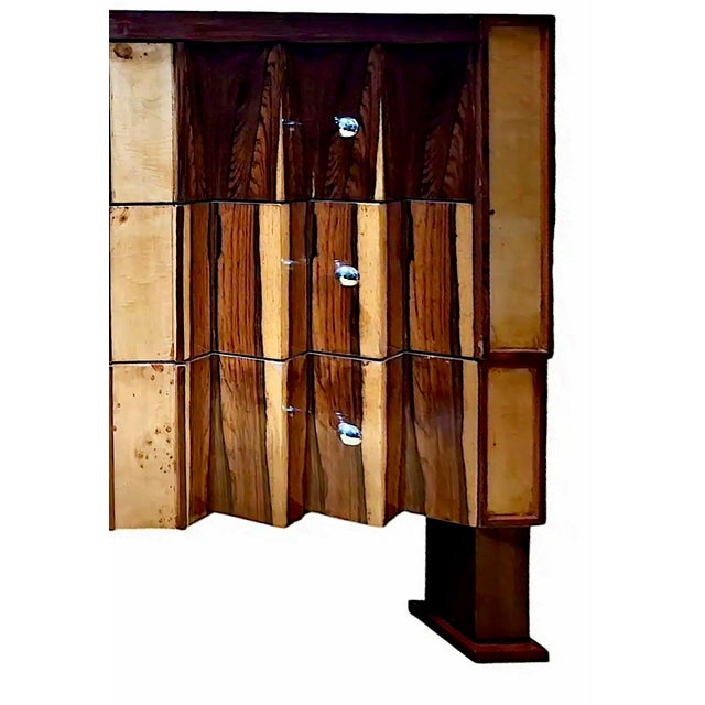 On offer is a classic Art Deco chest of drawers, remarkable for its geometric interplay of rosewood and walnut among the...