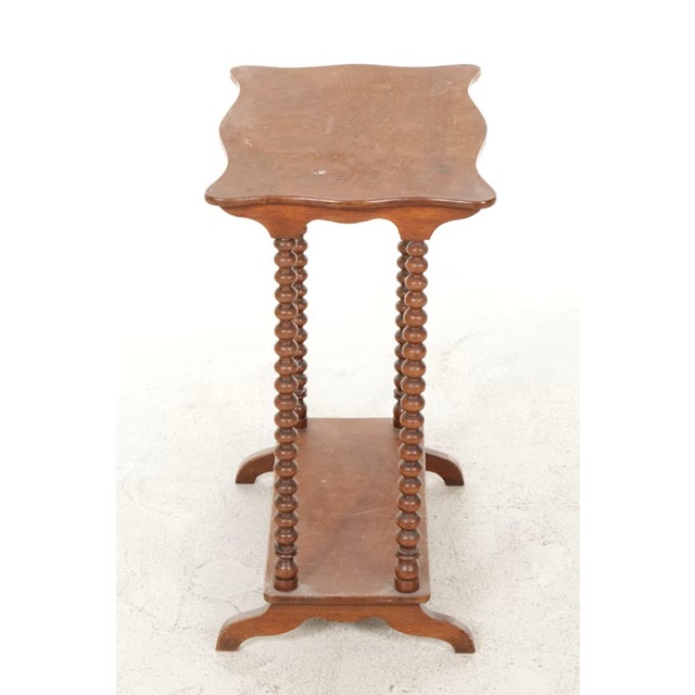 An exceptional 19th-century American Victorian walnut side table that epitomizes the delicate Victorian form. Defined by...