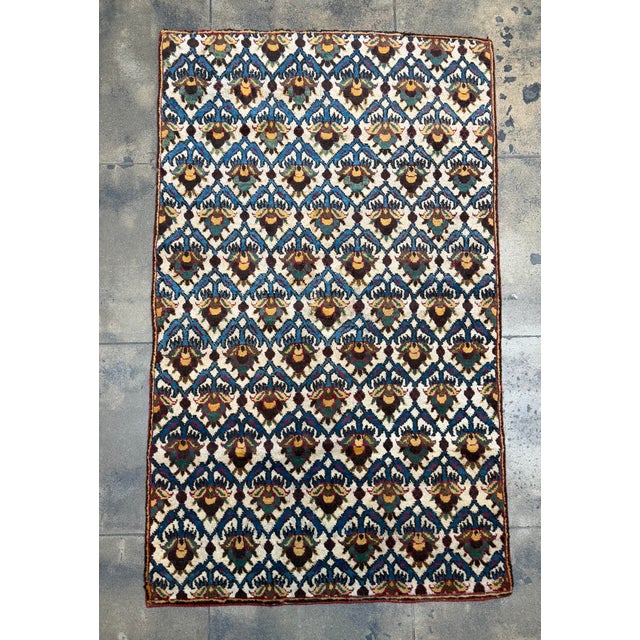 Antique Agra rug from the mid 19th century, handwoven in India and showcasing a highly distinctive geometric floral design...