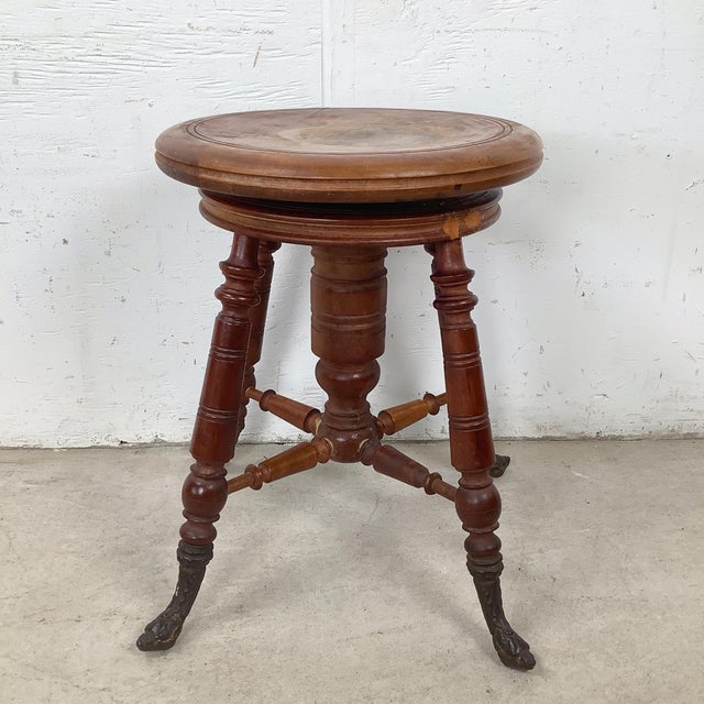 This antique piano stool reflects the richly detailed design language of the late nineteenth century, when functional...
