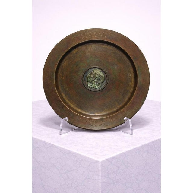 A substantial and finely cast bronze presentation plate designed by Sune Bäckström, Sweden, circa 1930s. This piece was...