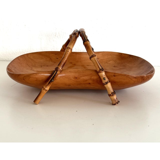 A stylish basket made of walnut with curved bamboo handles. It is a fine piece of craftsmanship; the basket is varnished...