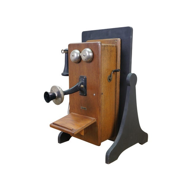 Early 20th century oak case hand crank wall hanging telephone produced by Sears, Roebuck & Company. Features long wood...