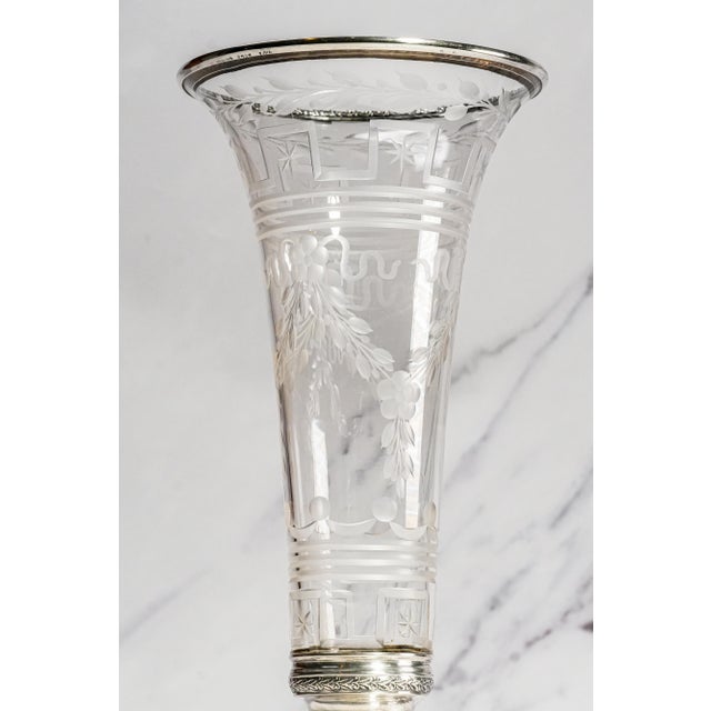 Dating to circa 1915, this elegant antique vase is a striking marriage of finely etched glass and substantial sterling...