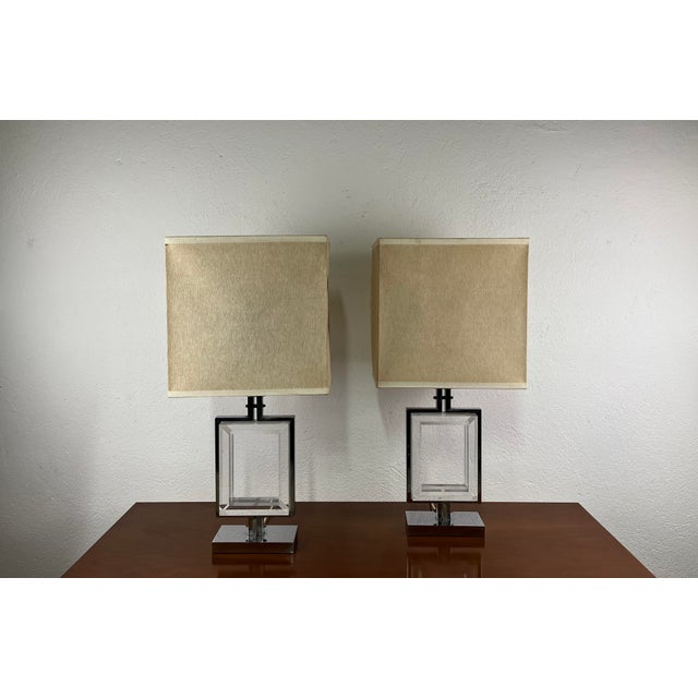 A pair of table lamps in chromed metal, acrylic glass, and a fabric lampshade, manufactured by Banci Firenze in the 1970s....