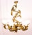 Floral chandelier gilded with gold leaf. Frame, branches, and candle holders adorned with acanthus leaves. Spiral stem....