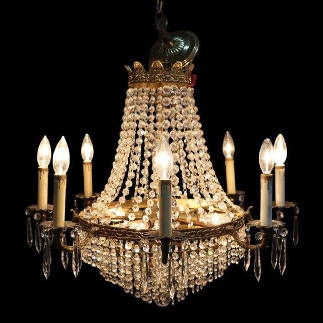 This exquisite vintage French Empire style chandelier, dating to approximately 1940, features a captivating 'crystal...