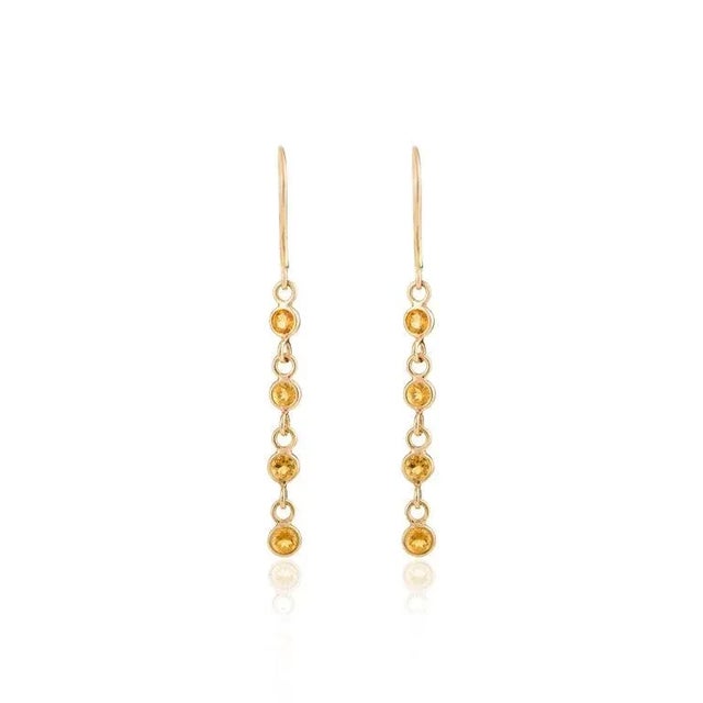 This is part of Chairish’s Fine Jewelry assortment. Tiny Citrine Dangle Earrings in 18K Gold to make a statement with your...