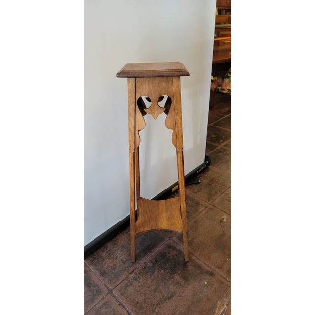 A nice tall Pedestal Plant Stand oak from England. Sturdy and nice wood design. Top and one shelf at bottom. All solid oak.