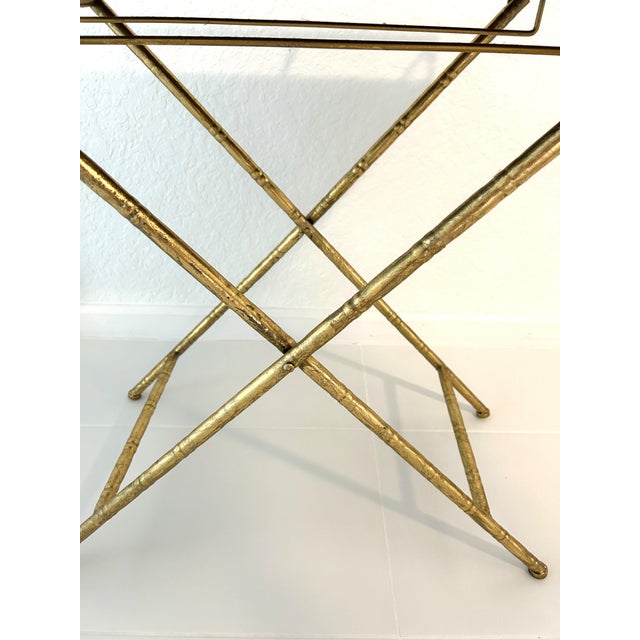 Stylish, gold-shaded, folding, metal bar table in a faux bamboo design with raised gallery and mirrored top. Great condition.