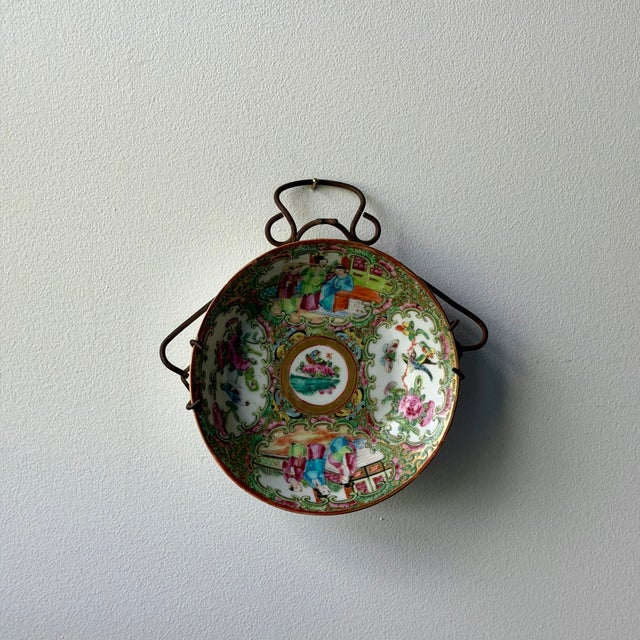Colorful antique Chinese famille rose porcelain bowl featuring hand-painted figures, birds, butterflies, floral motifs,...