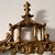 A large giltwood mirror with pagoda-style cresting, executed in the Hollywood Regency style. The architectural form is...