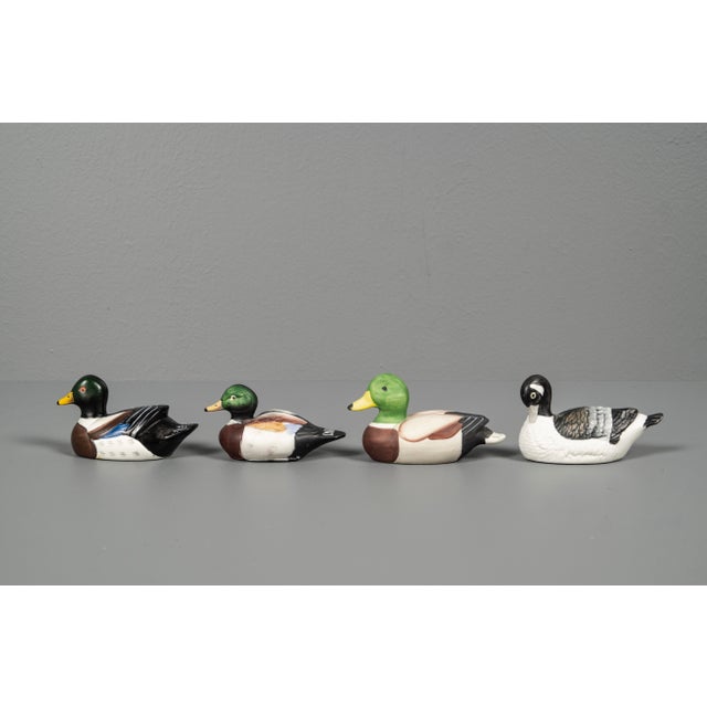 Decorative set of Porcelain ducks figures. The ducks feature warm green and blue and yellow tones with finely hand-painted...