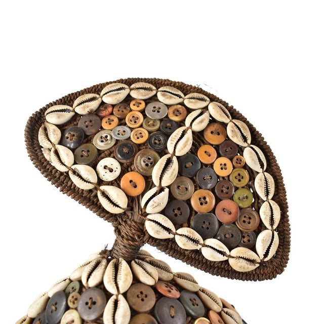 A stunning Lega Bwami Society hat from the Democratic Republic of the Congo. Adorned with colorful buttons, cowrie shell...