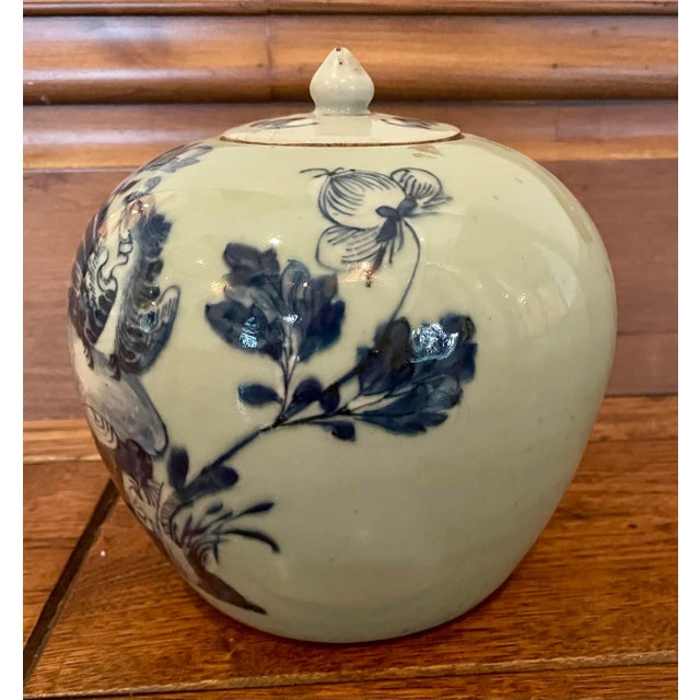 Antique Chinese blue-and-white porcelain covered jar featuring hand-painted floral and bird motifs in underglaze cobalt...