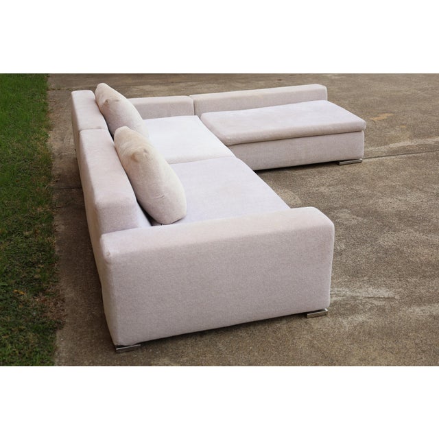 Beautiful timeless sectional sofa by Minotti. In three sections with chrome plated feet. Ready for new upholstery in your...