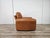 1970s orange leather armchair, Piumotto model designed by Arrigo Arrigoni for Busnelli. The armchair, with its modern and...