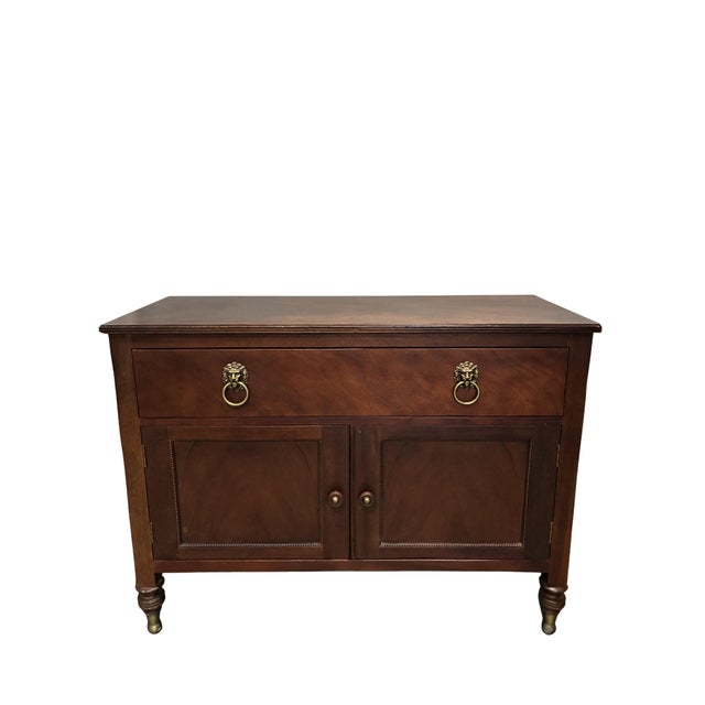 An elegant Baker Furniture Milling Road Collection mahogany server or sideboard featuring timeless neoclassical-inspired...