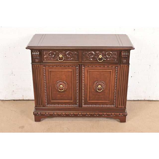 An exceptional English Jacobean or Tudor style sideboard buffet, server, or bar cabinet By Berkey & Gay USA, Circa 1920s...