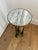 Vintage pedestal with a white and gray marble top and ornate brass base. Features three fluted legs with decorative...