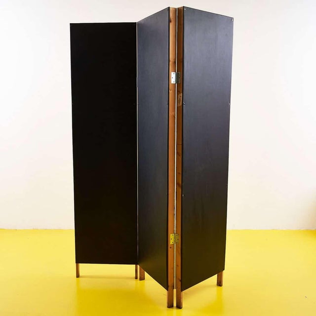 This charming vintage screen is a design object that evokes a sense of nostalgia and style. The wooden frame is decorated...