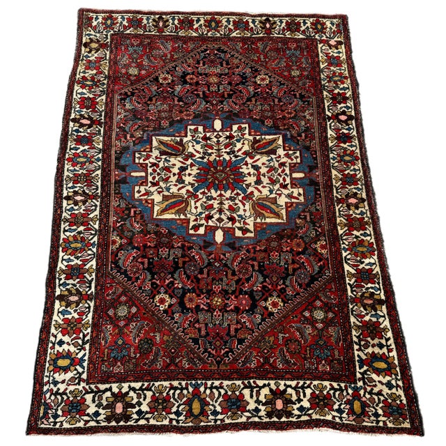 A fabulous antique Bidjar rug, hand woven circa 1900. The rug features an indigo field of Herati design around a large...