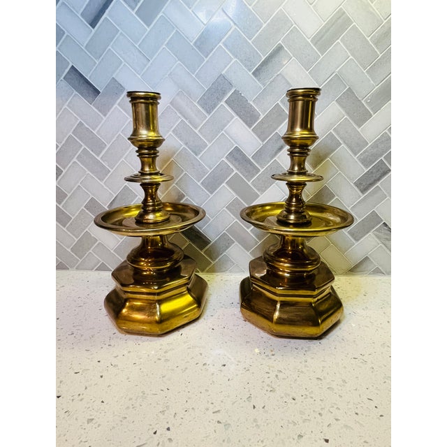 This pair of vintage solid brass candlestick holders feature an octagonal base, traditional design and a red felt base....