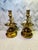 This pair of vintage solid brass candlestick holders feature an octagonal base, traditional design and a red felt base....