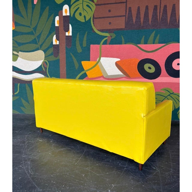 Super fun and vibrant yellow vinyl pullout loveseat. Manufactured by the renowned makers of functional furniture of the...