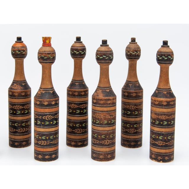 A set of nine vintage Scottish Carpet Ball pins. This set is turned hardwood and individually painted, featuring carved...