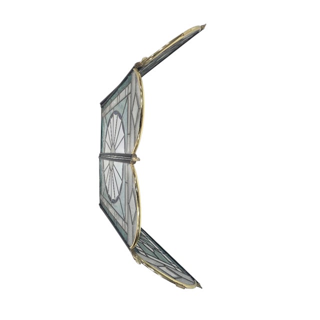 This beautifully crafted stained glass fireplace screen features a striking sunburst medallion at the center with...