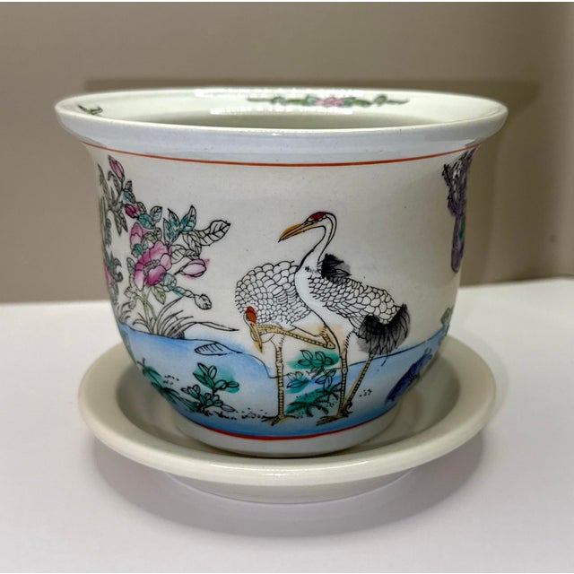 Vintage Chinese porcelain planter with its original matching tray, featuring an elegant hand‑painted crane scene...