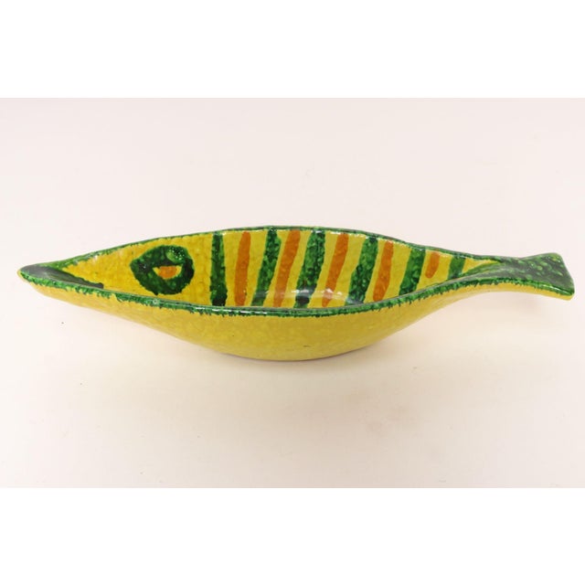 Italian Modernist slender, elongated, ceramic 'fish' form vide poche/decorative dish in vibrant yellow, orange, and green...