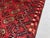 A vintage Afghan Ersari Turkmen rug in the classic Bokhara design — three columns of quartered octagonal güls march in...