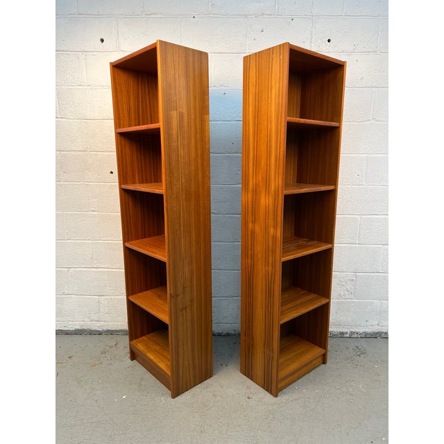 Beautiful pair of vintage mid century modern teak bookcases featuring a clean Danish-inspired design with rich teak grain...
