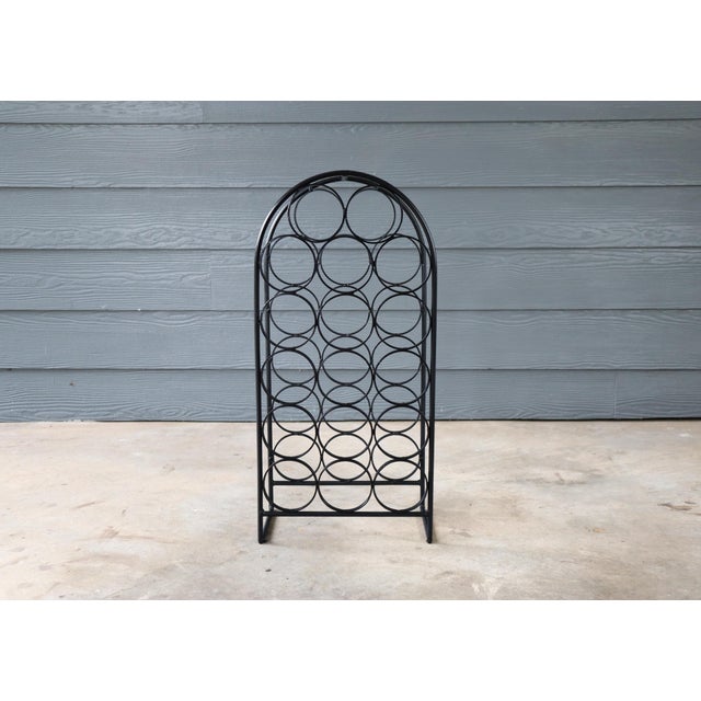 Stylish vintage iron 17 bottle wine rack/holder designed by Arthur Umanoff for Shaver Howard. This is in good condition...