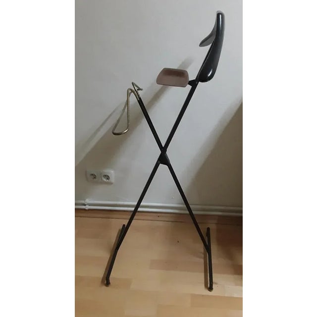 Vintage valet stand from the 70s with a black folding metal frame with brass handle and a teak bowl from Silva, Sweden