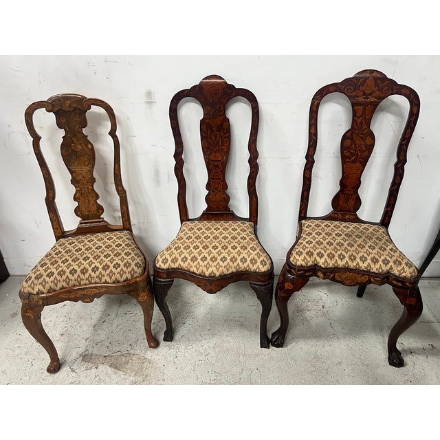 Set of eight Dutch chairs of different models Inlaid wood with masks, birds, vases, and foliate motifs Five chairs of the...