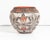 An Acoma Pueblo pottery vase by the Native American ceramicist Corrine Chino. This vase features a rounded shape with an...