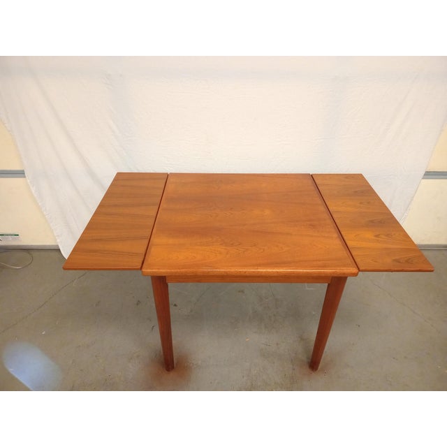 Mid-Century Danish Modern BDR Furbo Space Saver Square Dining Table Offered is a Danish Modern teak extension dining...