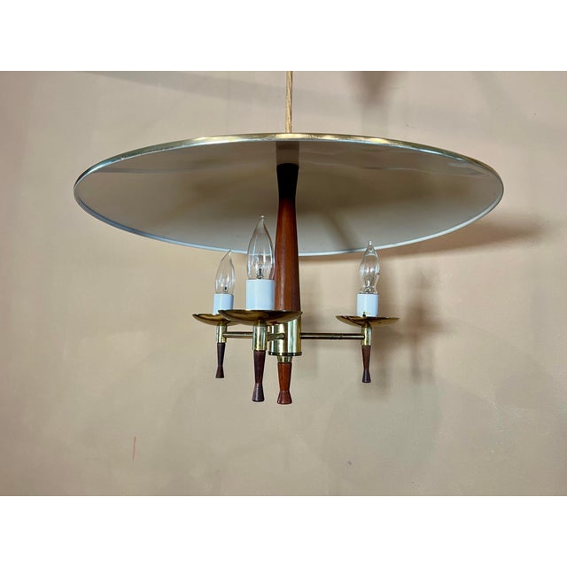This eye catching, Jetsons style ceiling fixture brings style to any room. The flying saucer chandelier features a brass...