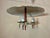 This eye catching, Jetsons style ceiling fixture brings style to any room. The flying saucer chandelier features a brass...