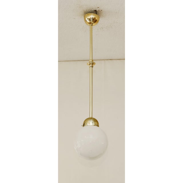 Art Deco Pendant Lamp Art Deco lamp made around 1920. Dish-shaped brass ceiling rose and shade cover. Mounted on a brass...